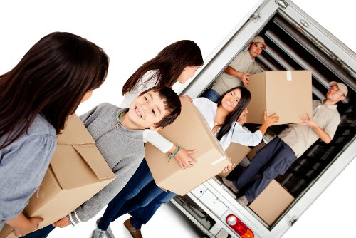 Man with van loading furniture in Newbury Park residential street