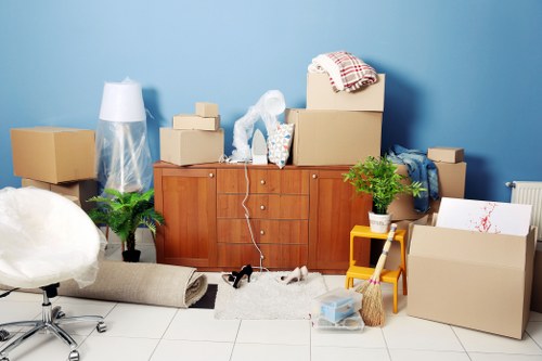 Movers handling furniture and boxes in a Newbury Park apartment move
